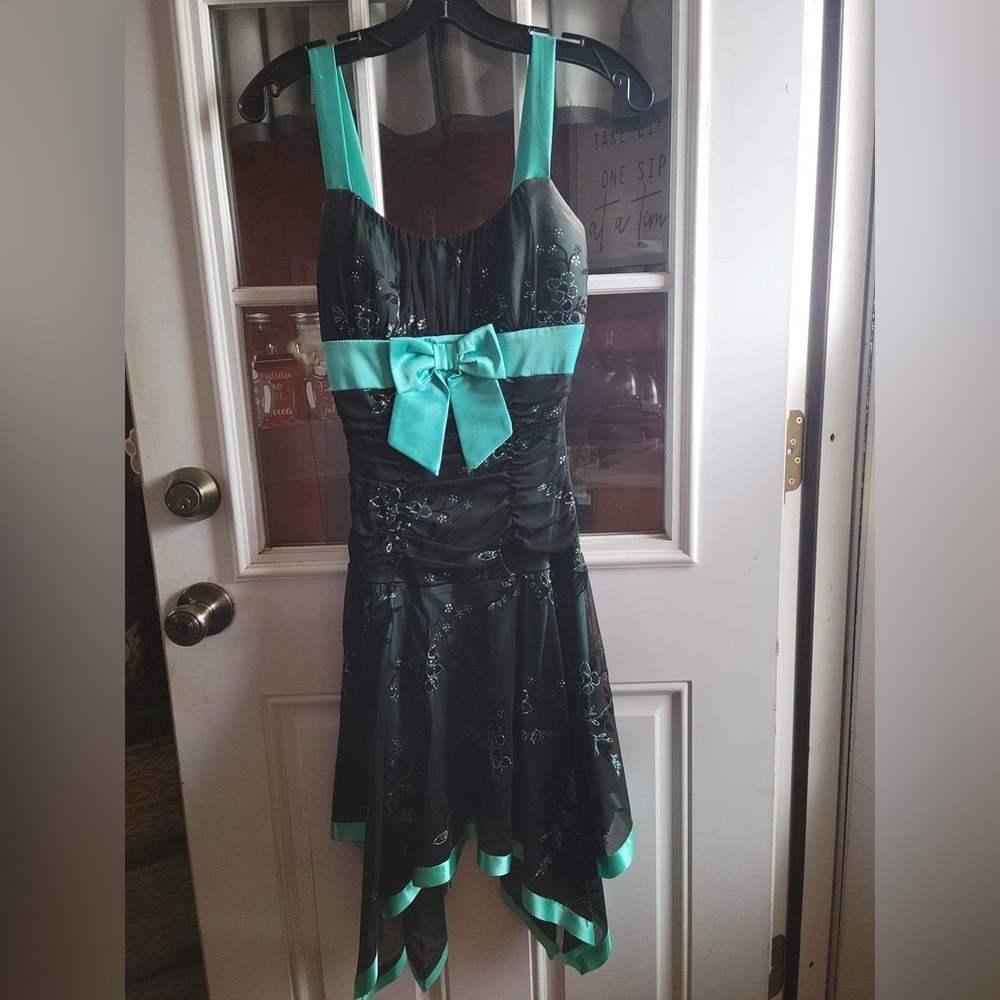 Black and teal dress, with teal bow and pretty flower details